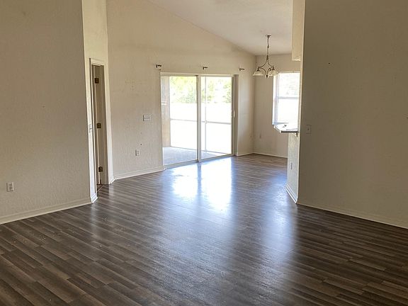 Family room with fan and vaulted ceilings
