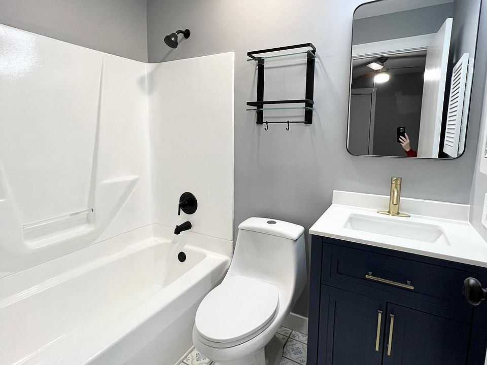 Newly remodeled, modern bathroom with brushed bronze and black accents.