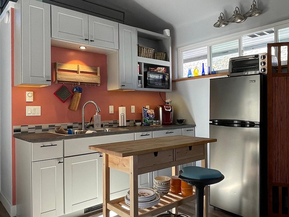 Fully stocked kitchen includes refrigerator; convection, induction, and microwave cooking; dinner and cook ware.