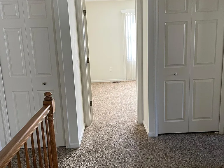 Second floor hallway with double storage closets