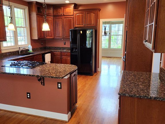 kitchen with granite countertops, gas stovetop, lots of cabinets
