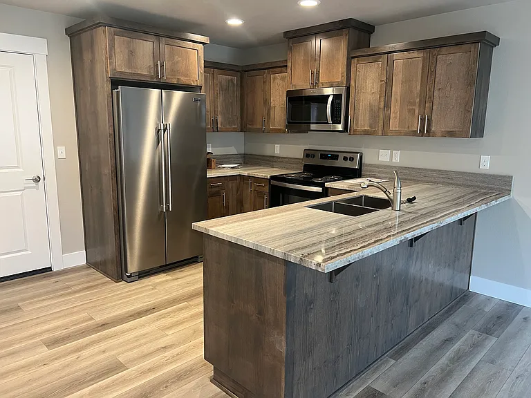 Kitchen with stainless appliances, dishwasher, stove and microwave.