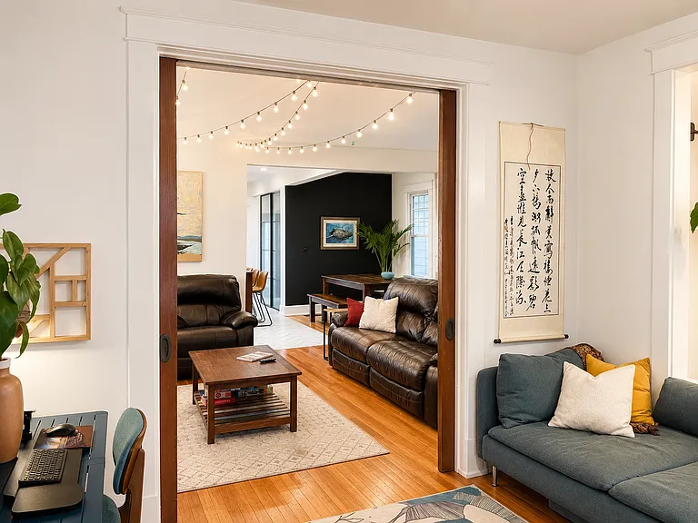 Open pocket doors connecting the living room and reading room