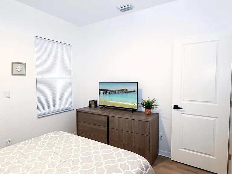 Each bedroom features a queen sized bed, a wall mounted Smart TV, and plenty of closet space.