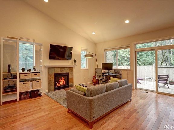 Gorgeous hardwood floors, open concept, soaring ceilings, tall window, private deck, full fenced yard. 