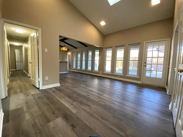 Family room with high ceilings, skylight, and windows galore!