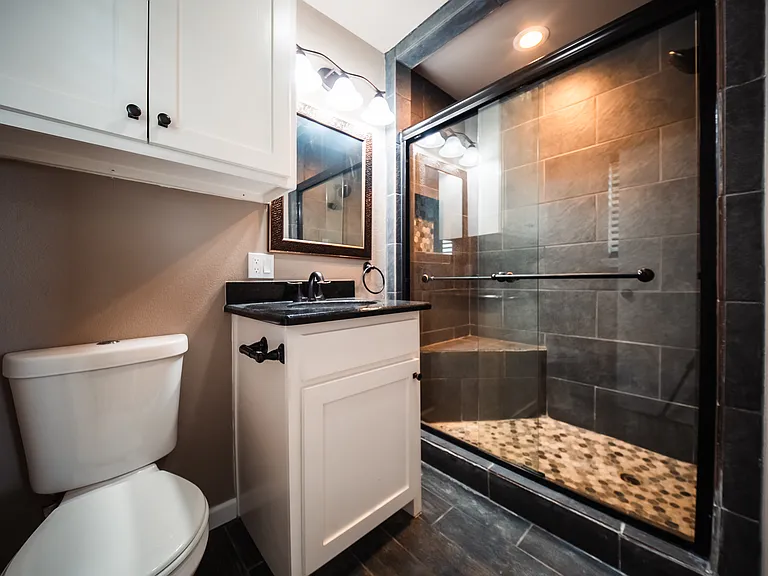 Bathroom with stone countertop vanity and ample mirror space