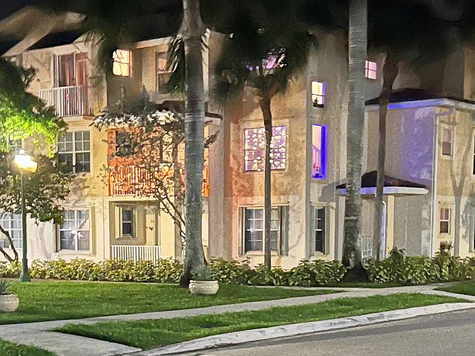 Exterior view showing unit's windows and two balconies at night