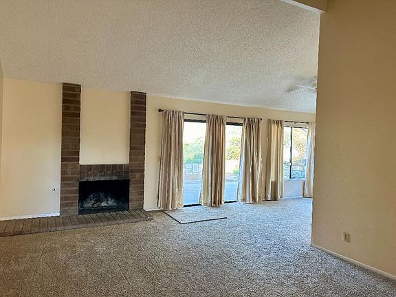 Living room with vaulted ceiling trimmed with brick