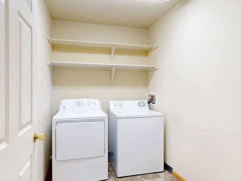 In-home laundry with built-in shelving makes everyday chores more convenient and organized.