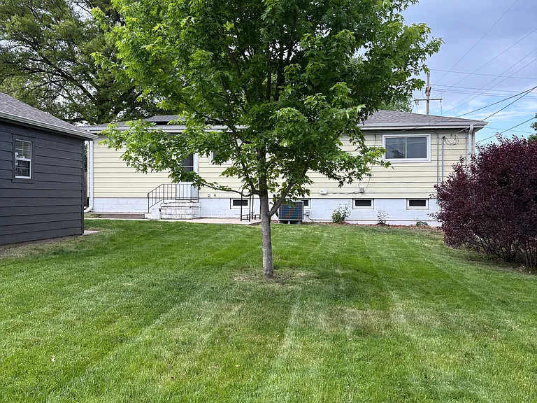 Large flat back yard with shed.