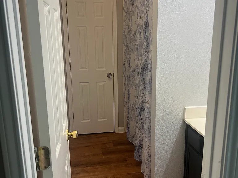 Bathroom, second floor, contains sink and tub. Toilet behind back door