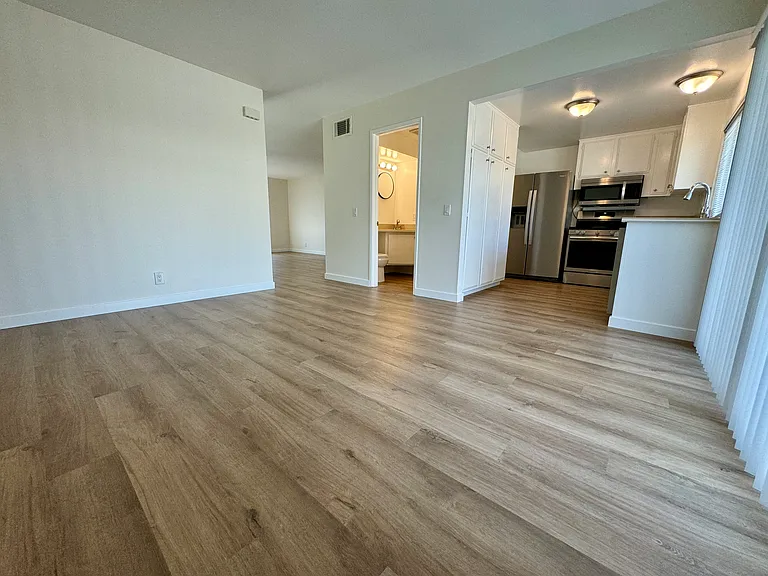 Dining/family room with new vinyl plank flooring, new paint & blinds!