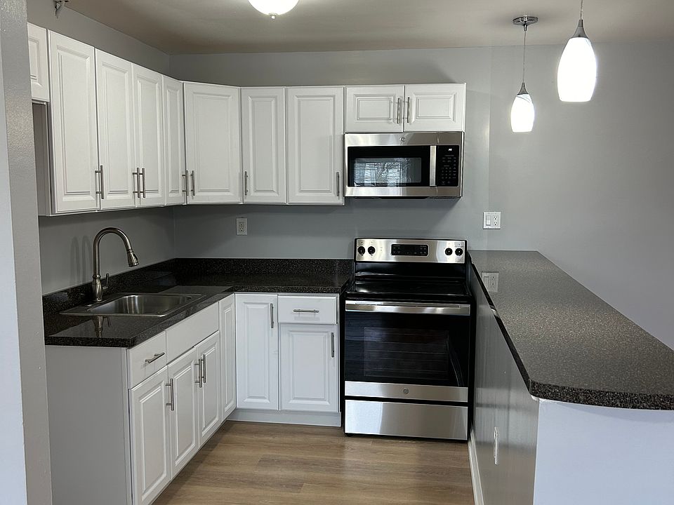 Kitchen with stainless steal fridge, range and microwave