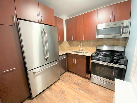 All stainless appliances, including GE Cafe fridge, GE Cafe microwave, GE gas range, dishwasher and wine cooler