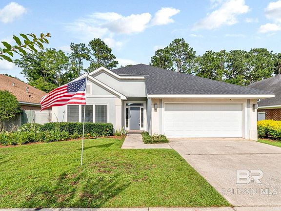 View of front of property with a garage and a front lawn
