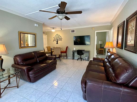Walk through the front door and encounter the open space family room adorned with comfortable leather furniture.