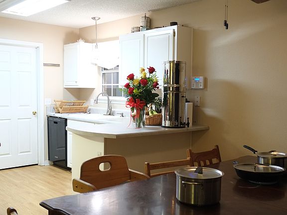 View of dining area and kitchen from living area.