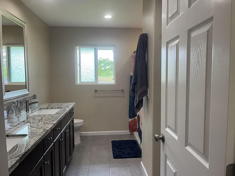 En suite bathroom w double vanity, walk in closet and over sized shower surround