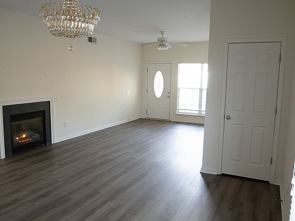Living room with fire place and storage closet.