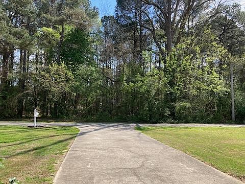 View from front of 110 Pecan Lane. Tree filled 3 acres provide privacy.