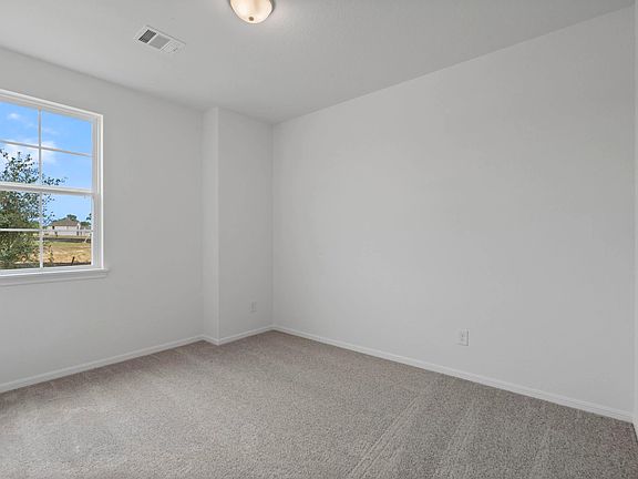 Your secondary bedroom features plush carpet, fresh paint, closet, and a large window that lets in p
