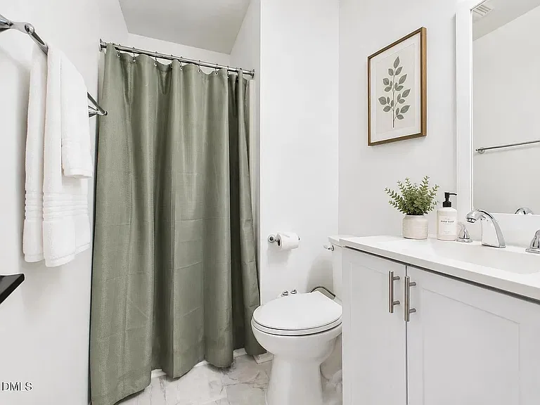 Second bathroom with stand in shower.