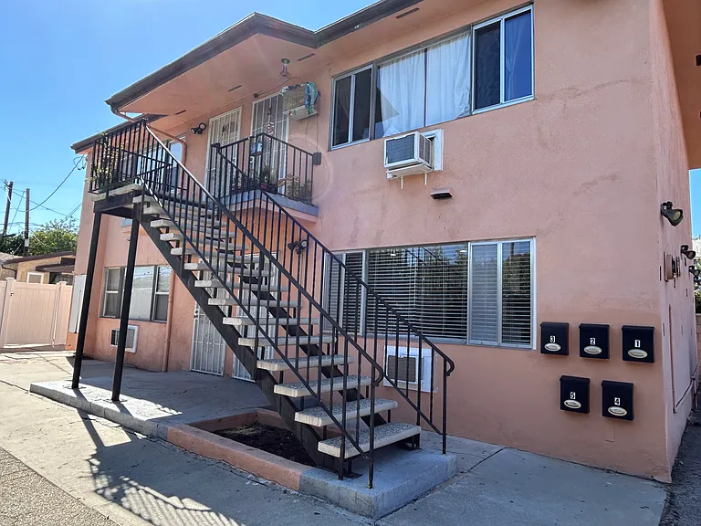 View of apartment building. There are four units total. Unit #1 is the one on the lower level to the right.
