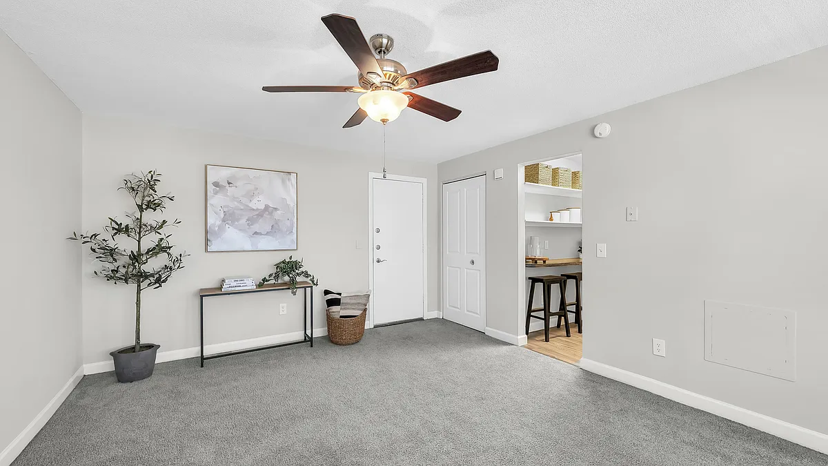 Enjoy the cozy living area with the added comfort and lighting of a ceiling fan. Some homes feature plush carpeting for that extra touch of luxury. - Beacon Square
