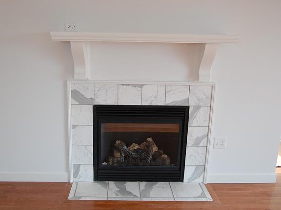 Working fireplace with antique mantle and marble surround