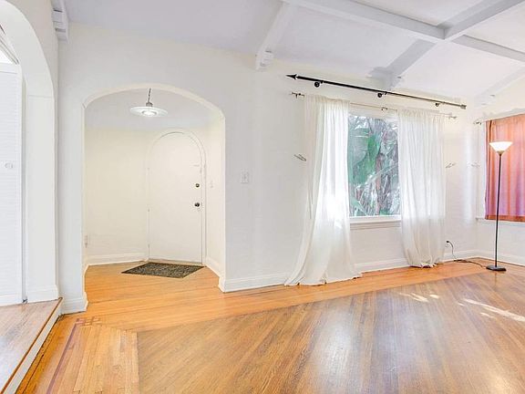 Living room with step_up formal dining room on left.