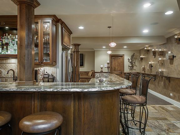 Wrap-around lighted bar-granite, custom cabinetry,