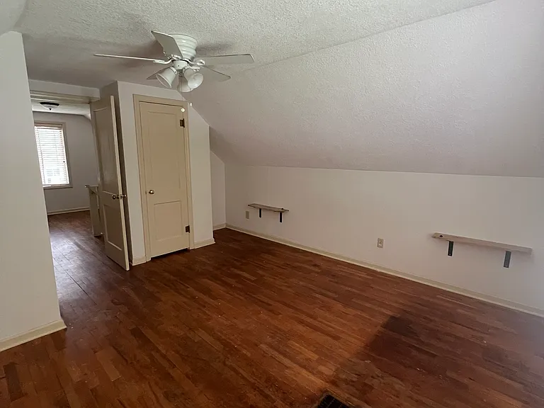 Upstairs Bedroom with attached nightstand shelfs that accommodate a king bed