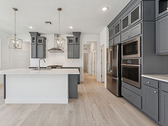 Kitchen with stacked glass-front upper cabinets