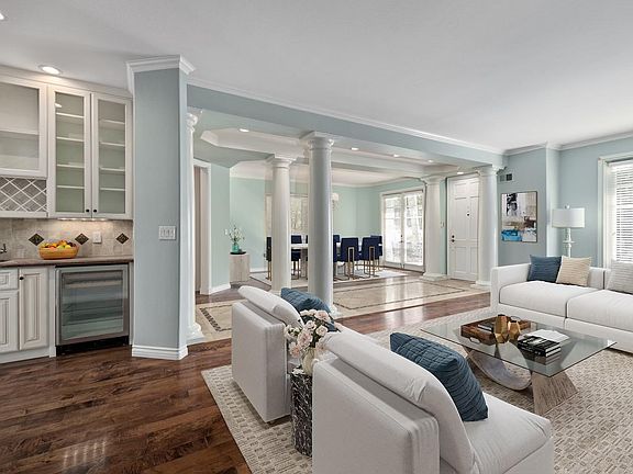 Front entry, two sets of french doors, living room, dining room and bar