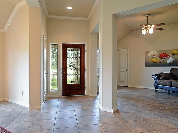 Friends enter the home thru an elegant beveled, leaded glass front door and witness an impressive Fo