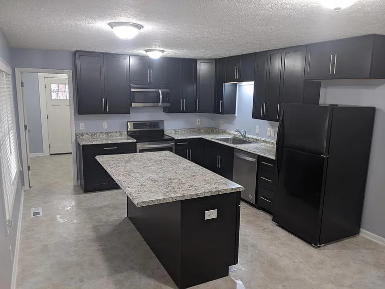 Brand new kitchen with huge island, lots of cabinets and countertops. very quiet Whirlpool dishwasher and Fridge, LG stove and microwave