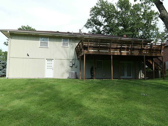 Back yard with large deck and walkouts from the kitchen, basement and garage