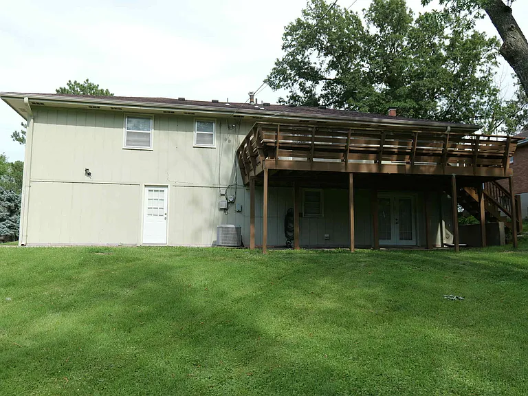 Back yard with large deck and walkouts from the kitchen, basement and garage