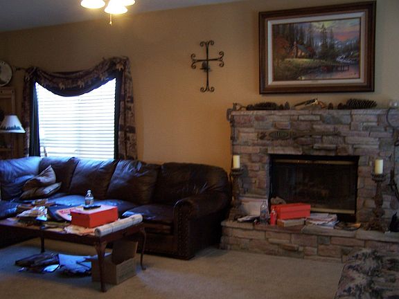 Greatroom has cozy fireplace with raise hearth and mantle
