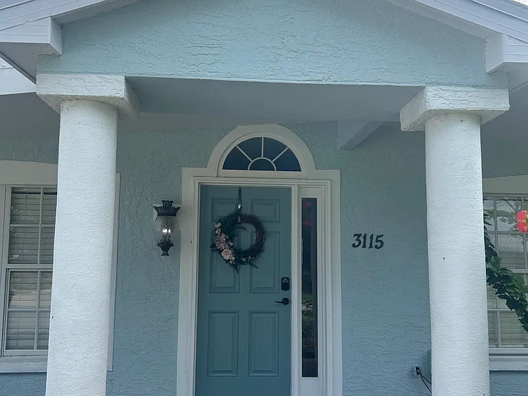 Beautiful stucco home with partial tile roof and metal
