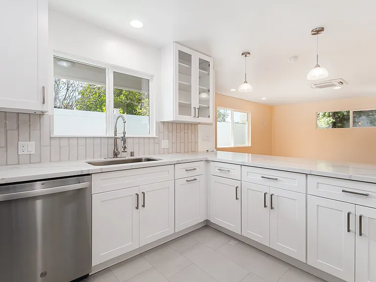 Full size kitchen with quartz countertops and subway tiles full back splash