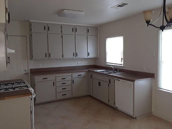 Nice-sized kitchen includes newer range/oven, dishwasher,
ne