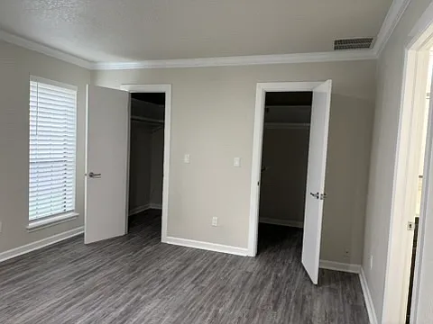 View of master bedroom with two closets.