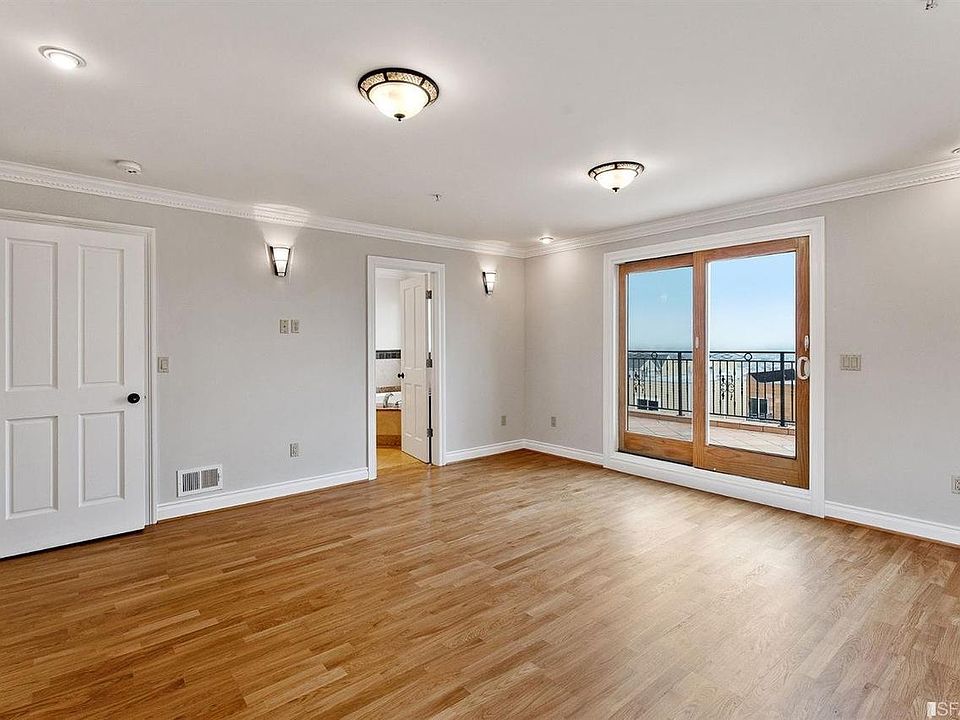 Bedroom with attached bathroom, walk in closet, and doors to private back deck