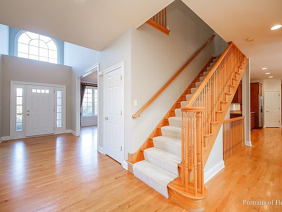 Bright, 2-story foyer opens to family room and stairs to 2nd level.