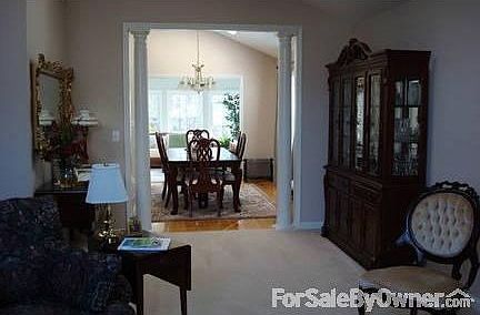 Living Room to Sunroom : .Open floor plan with living room, dining room, and sunroom / vaulted ceili