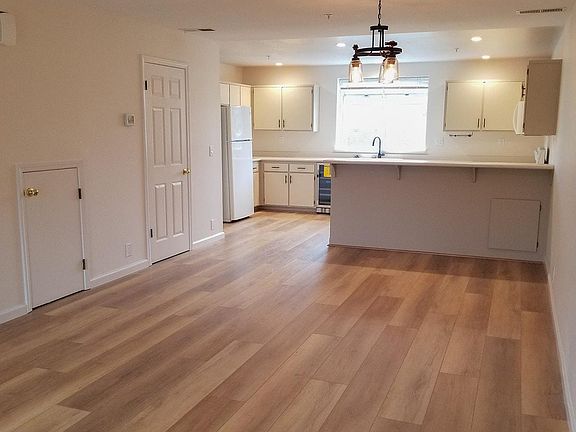 Living Room, Dining Room looking towards the kitchen. Door to half bath.