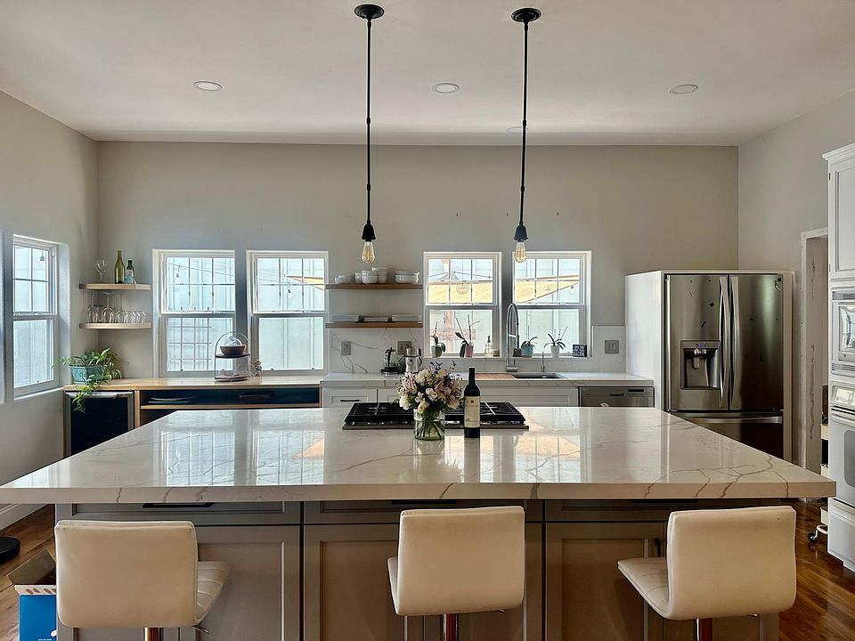 Kitchen recently remodeled. Granite counter top island. Storage on both sides. Floating shelves. Pendent lighting
