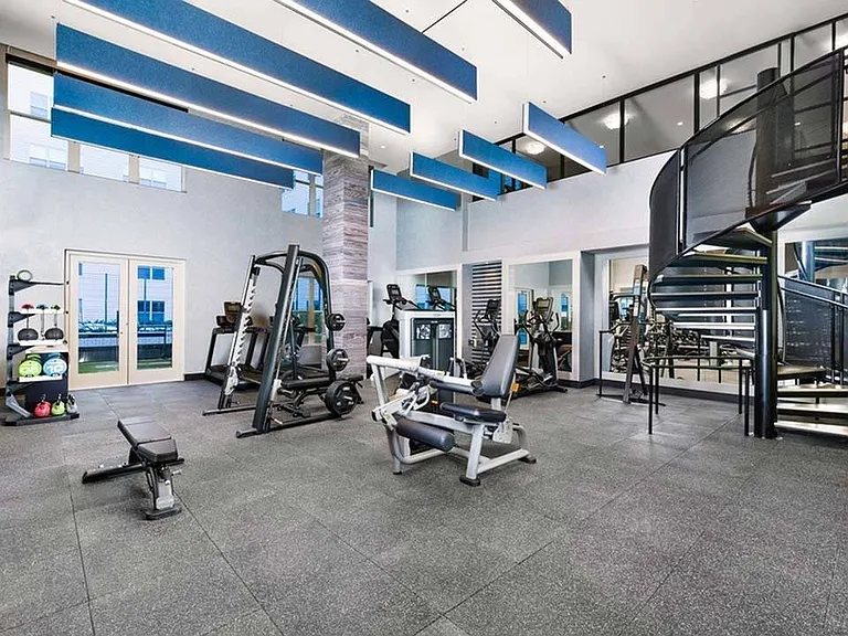 Two-level fitness center showing weight stations